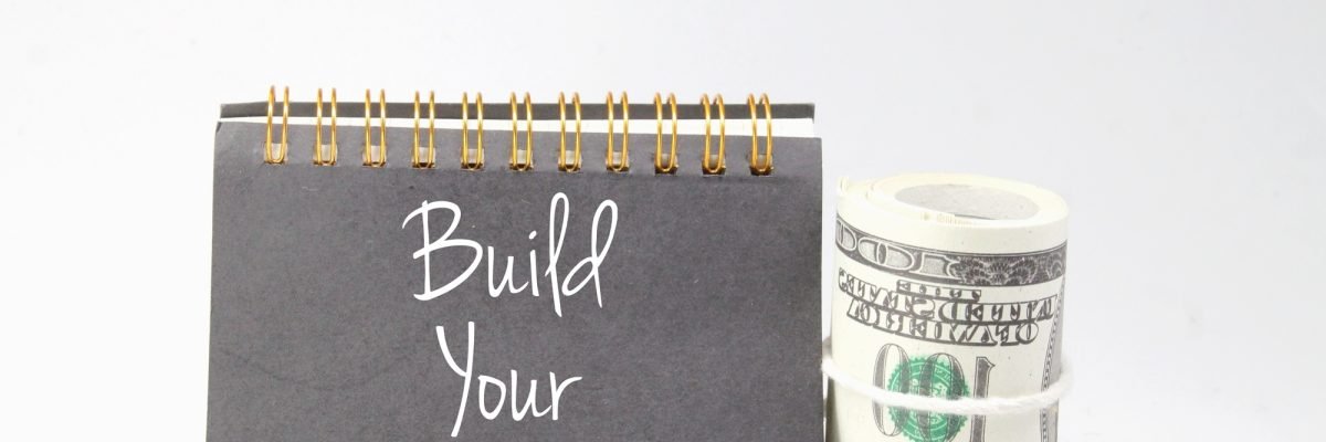 banknotes and books with the word build your brand.